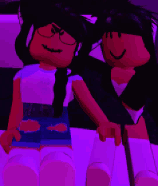 two dolls are sitting next to each other on a couch