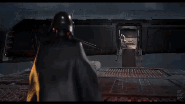 a person holding a red light saber in front of a door