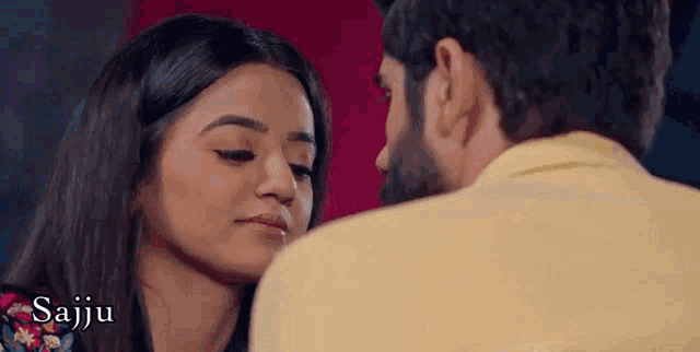 a man and a woman are kissing and the woman is looking at the man 's face .