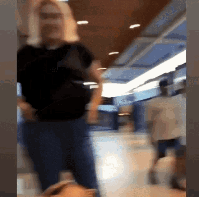 a blurry picture of a woman in a black shirt and jeans