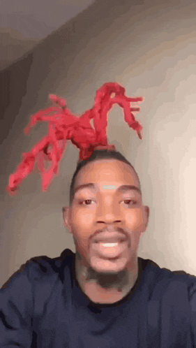 a man with a red object on his head .