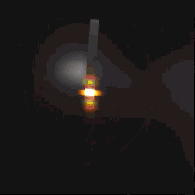 a black background with a white circle with a glowing light coming out of it