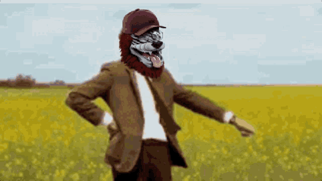 a man in a suit and hat is dancing in a field of yellow flowers
