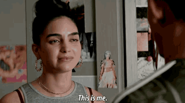 a woman in a grey tank top says " this is me "