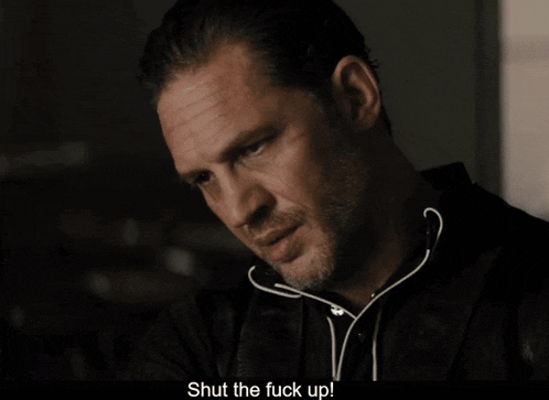 a close up of a man 's face with the words shut the fuck up below him