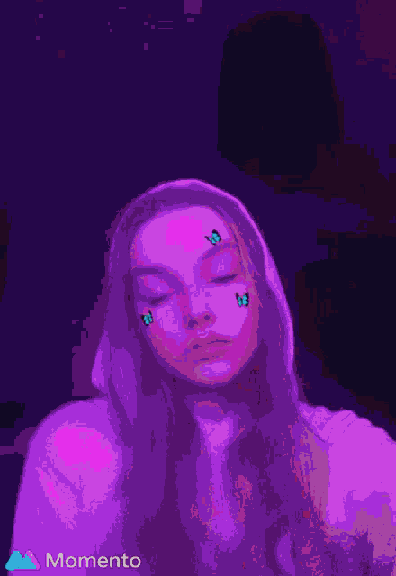 a girl with butterflies on her face is wearing a hoodie