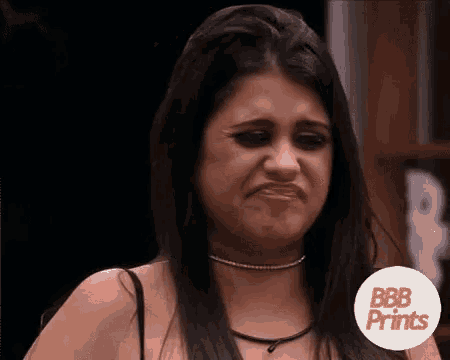 a woman is making a funny face with her mouth open and a choker around her neck .