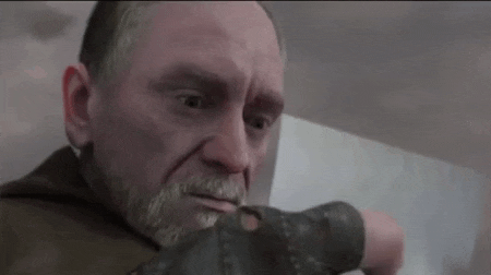 a man with a beard is wearing a glove and looking at something .