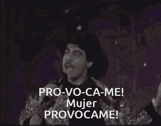 a woman singing into a microphone with the words pro-vo-ca-me mujer provocame on the bottom