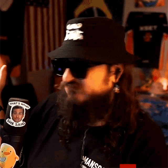 a man with a beard wearing a hat and sunglasses has a sticker that says that 's what some said