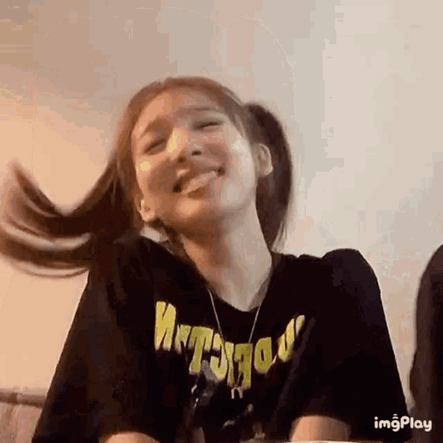 a woman in a black shirt is making a funny face .