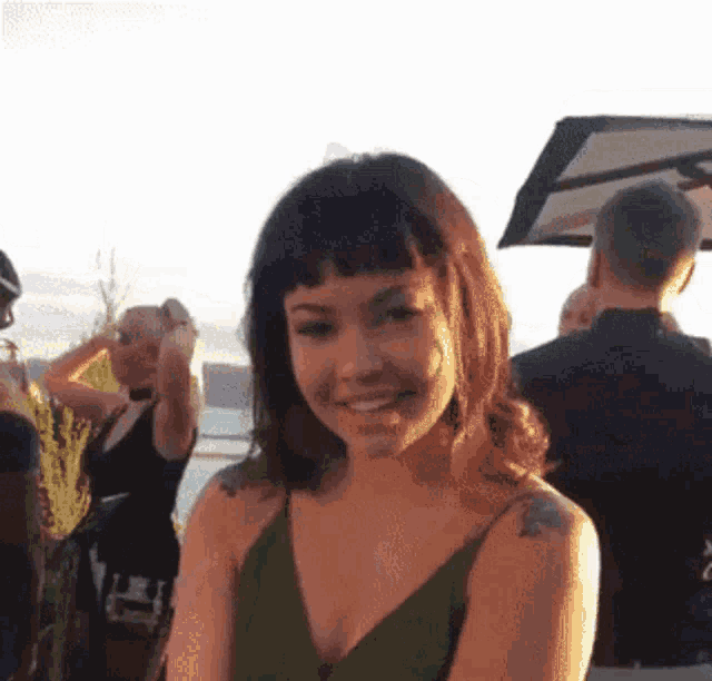 a woman with a tattoo on her arm is smiling
