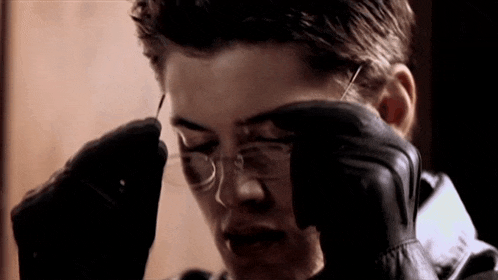 a close up of a person wearing glasses and gloves