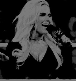 a woman is singing into a microphone that says wwe on it