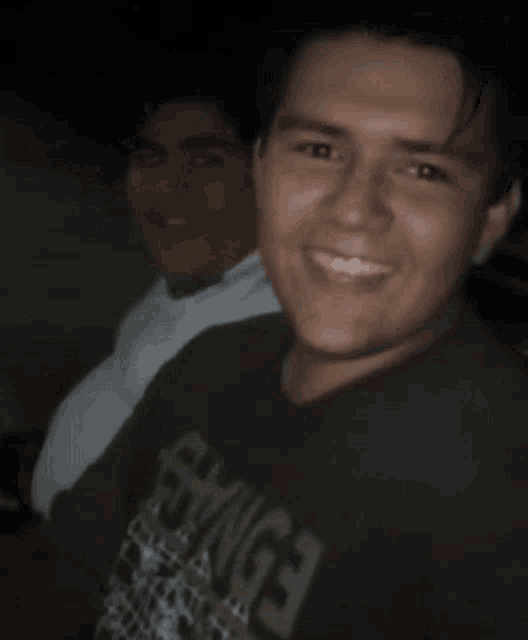 a man wearing a black shirt that says ' ss ' on it