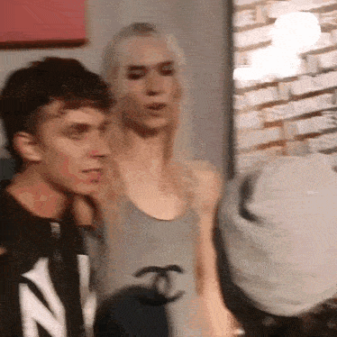 a man and woman are standing next to each other in a room .