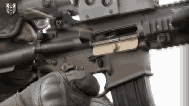 a close up of a rifle with a shield on it