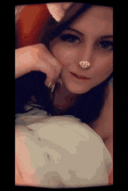 a close up of a woman with a nose ring on
