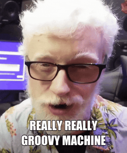 a man with glasses and a beard is saying really really groovy machine