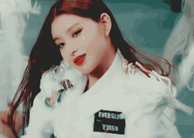 a girl with long hair is wearing a white shirt that says everglow on it