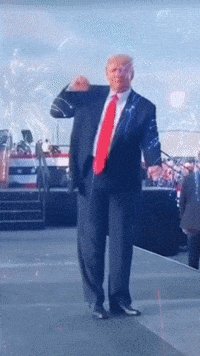 a man in a suit and red tie is standing on a stage