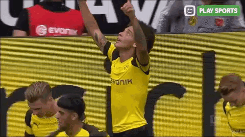 a soccer player in a yellow jersey with the word evonik on the front