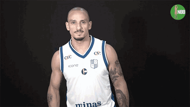 a man wearing a minas jersey stands in front of a nbr logo