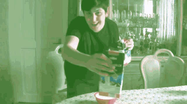 a man is pouring milk into a bowl while standing next to a box that says milk on it