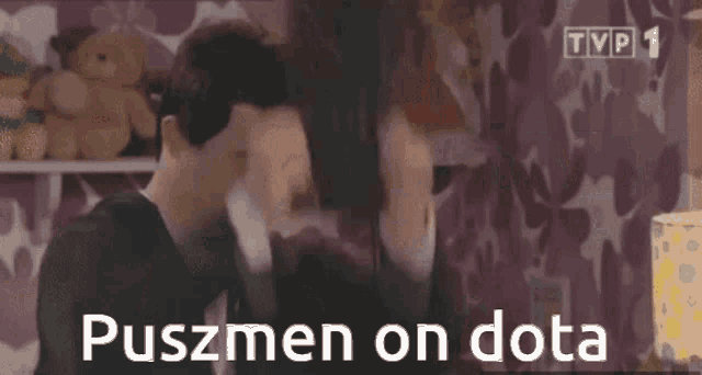 a woman is dancing in front of a tv with the words puszmen on dota