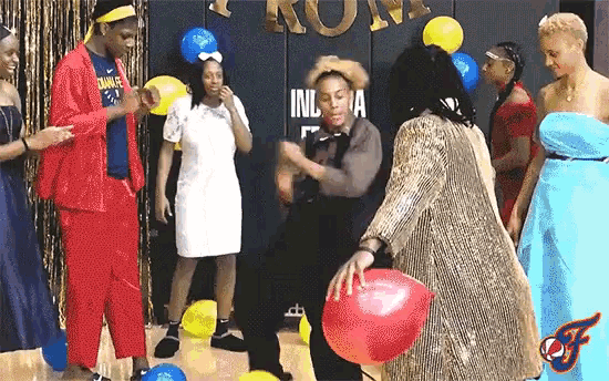 a group of people are dancing in front of a sign that says ' inl ' on it