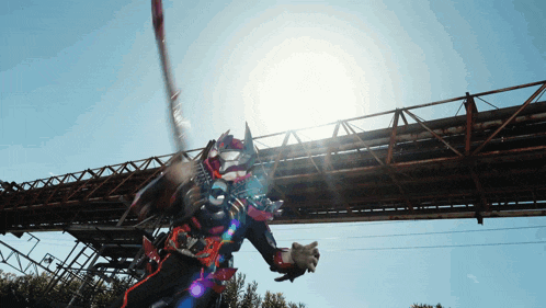 a person in a costume is standing under a bridge with the sun shining on them