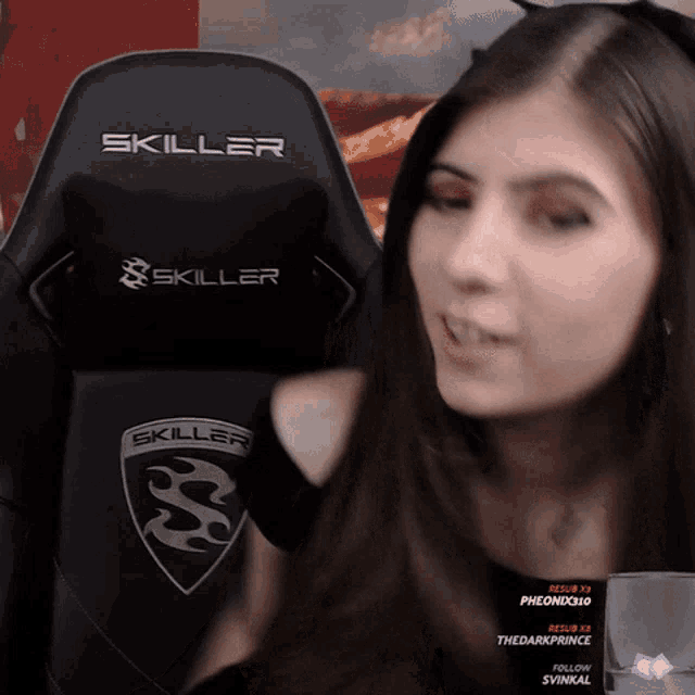 a woman sitting in a skiller chair looking at the camera