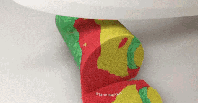 a slice of cake with a red yellow and green pattern