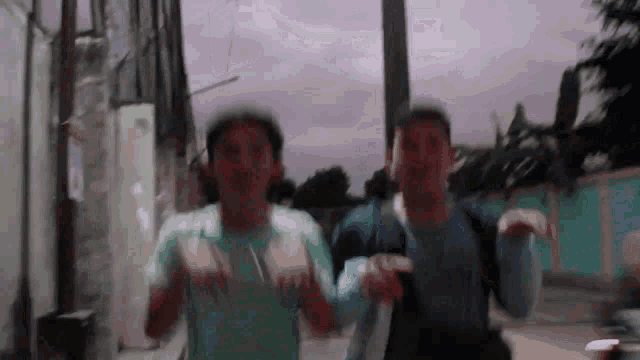 a blurry picture of two men dancing in a street