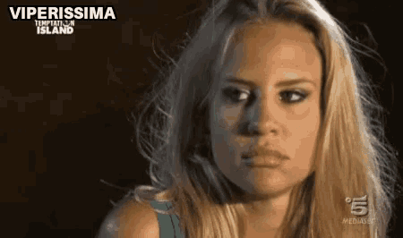 a close up of a woman 's face with the words viperissima temptation island written on the bottom