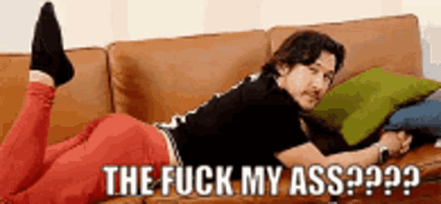 a man is laying on a couch with the words the fuck my ass