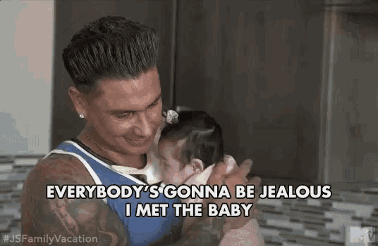 a man is holding a baby and saying `` everybody 's gonna be jealous i met the baby ''