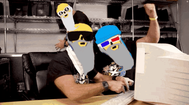 two men wearing 3d glasses are sitting in front of a computer screen