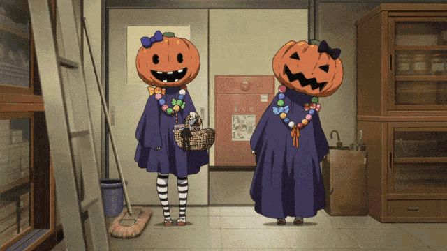 two girls wearing pumpkins on their heads are standing in a hallway