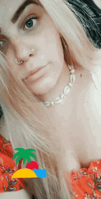 a woman wearing a nose ring and a necklace with shells