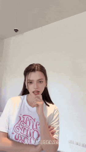 a woman is wearing a white t-shirt with the word hooduserie on it .