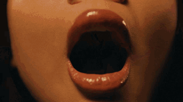 a close up of a woman with her mouth open