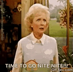 a woman is standing in front of a door with the words `` time to go nite nite '' .