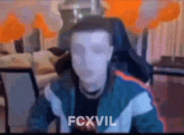 a blurry picture of a man sitting in a chair with the word fcxvil on the bottom