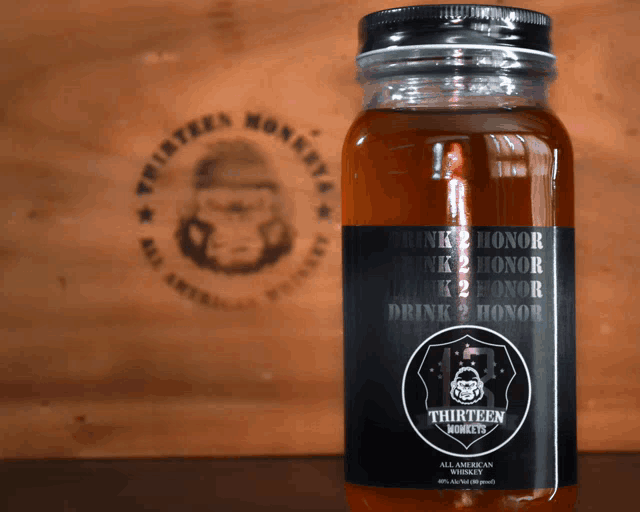 a bottle of thirteen monkeys whiskey sits on a table