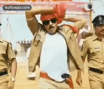 a man in a police uniform is dancing with a red turban on his head .