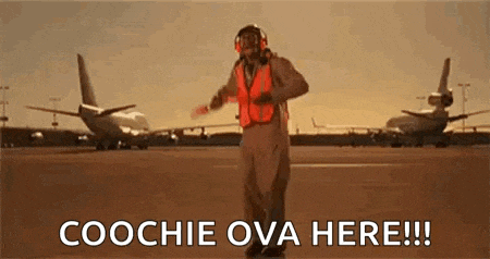 a man in a helmet is standing on an airport runway .