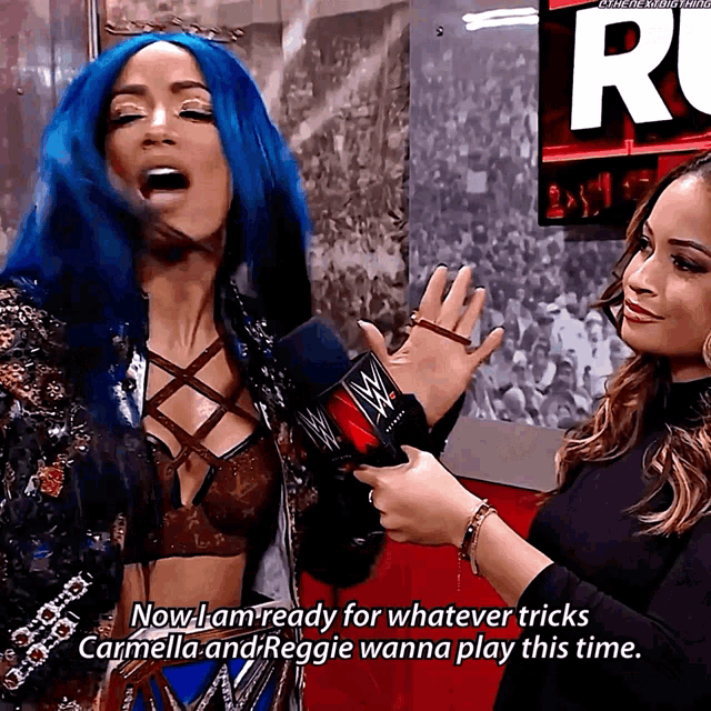 a woman with blue hair is being interviewed by another woman