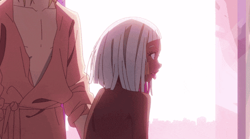 a woman with white hair is standing next to a man in a robe