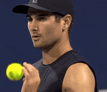 a man wearing a baseball cap with the letter v on it